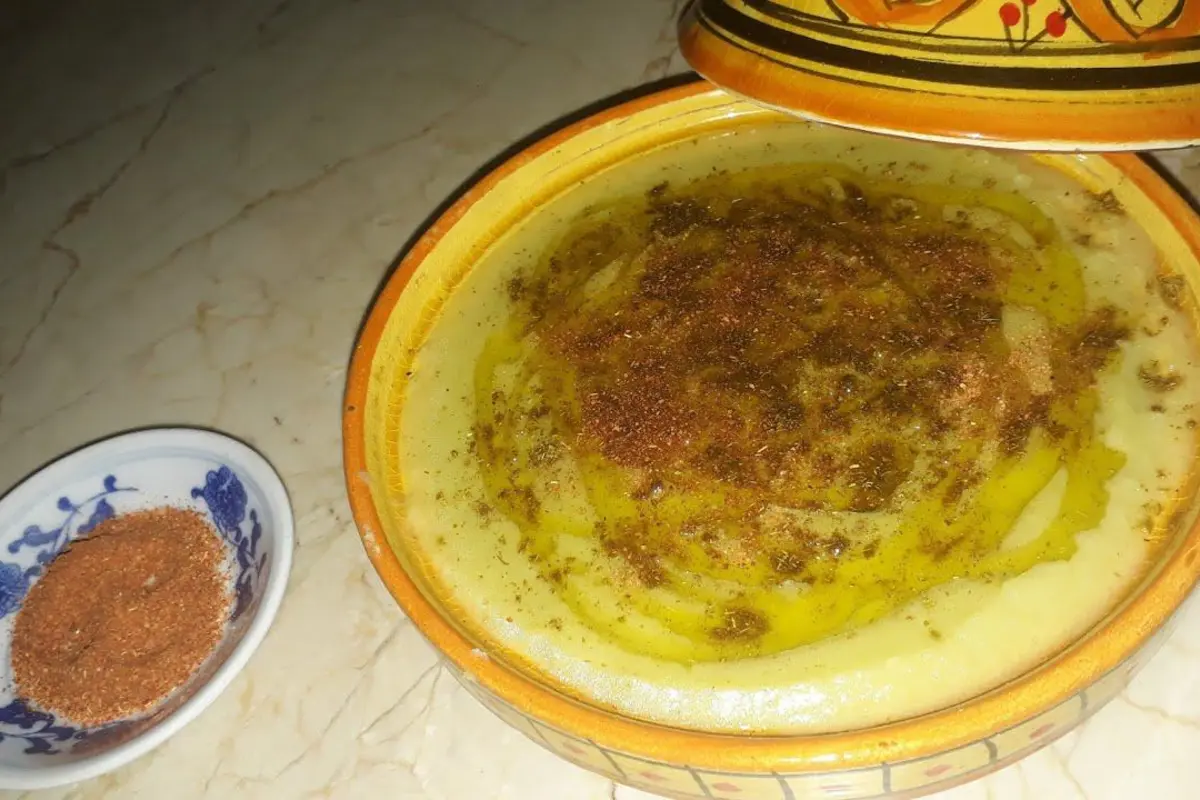Bowl of creamy Moroccan Bessara soup drizzled with olive oil, cumin, and paprika