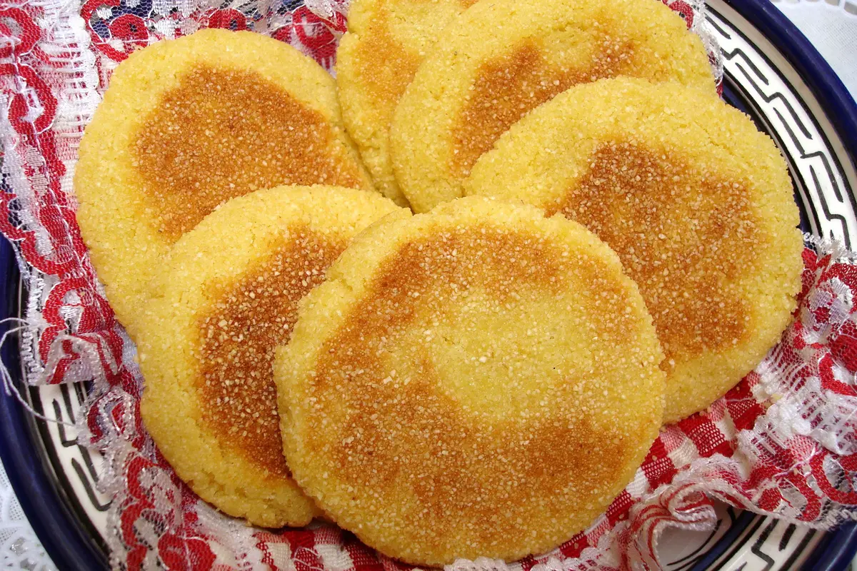 Golden round Moroccan Harcha semolina bread toasted in a skillet