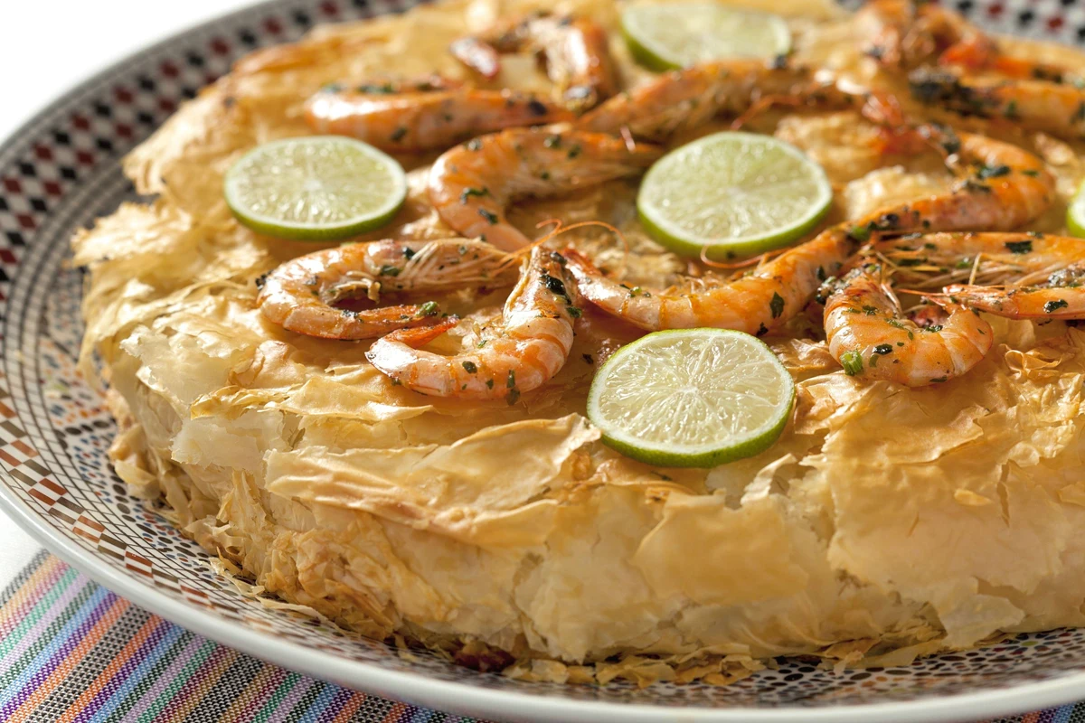 Traditional Moroccan Chicken Bastila decorated with powdered sugar and cinnamon lattice